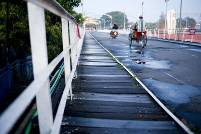 People on footbridge in city