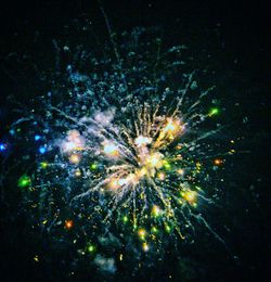 Low angle view of firework display at night