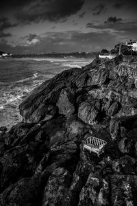 Scenic view of rocks on beach against sky