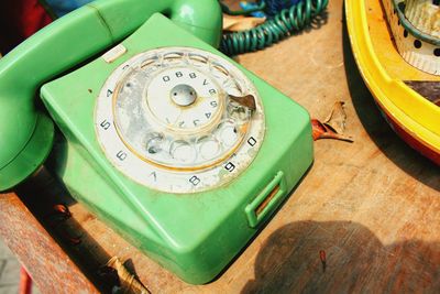 High angle view of old telephone on table