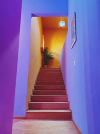 Low angle view of steps amidst buildings against sky