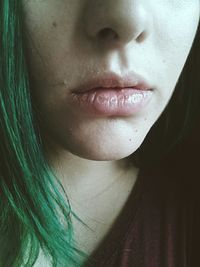 Cropped image of woman with dyed green hair