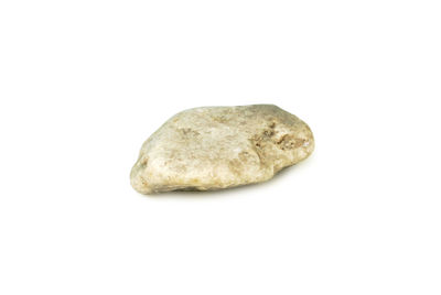 Close-up of bread on rock against white background