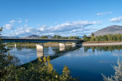 Arch bridge over river against sky