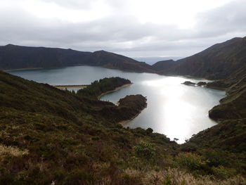 Scenic view of lake and mountains against sky