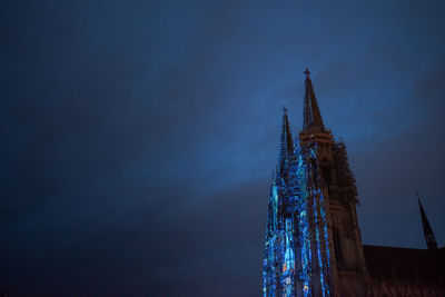 Low angle view of illuminated building against sky at night