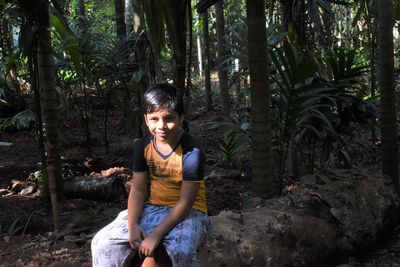 Portrait of a smiling young woman in forest