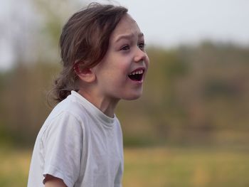 Portrait of smiling boy looking away outdoors