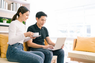 Young couple holding smart phone