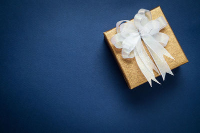 Directly above shot of gift box against blue background