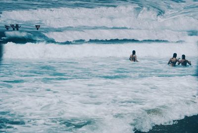 People swimming in sea