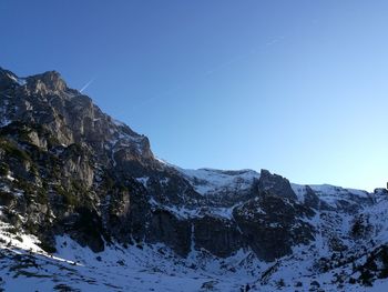 Scenic view of snowcapped mountains against clear sky