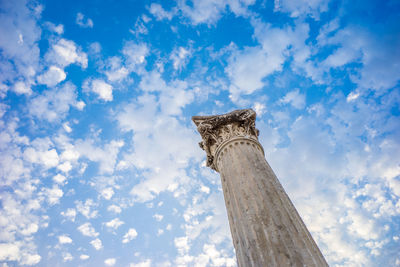 Low angle view of tower against cloudy sky