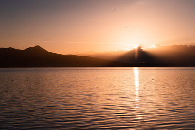 Scenic view of lake against sky during sunset