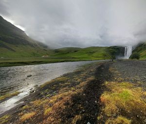 Scenic view of mountains against cloudy sky