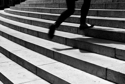 Low section of woman standing on staircase