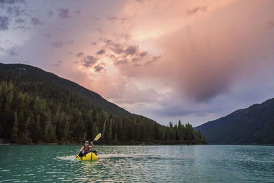 Man paddling inflatable packraft on cheakamus lake, whistler, b.c.