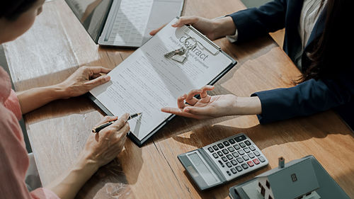 High angle view of people using laptop on table