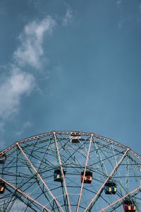 Low angle view of ferris wheel against sky