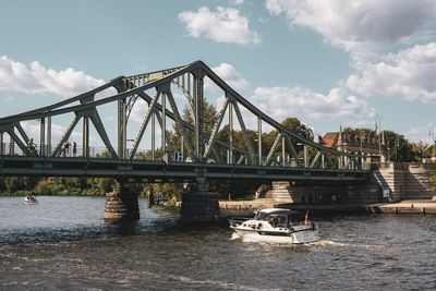 View of bridge over river against cloudy sky