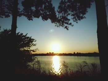 Scenic view of lake against sky during sunset