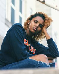 Portrait of young woman sitting outdoors