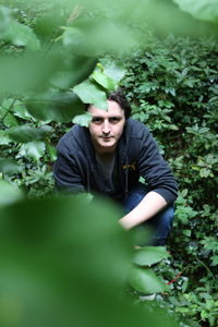 Young man wearing sunglasses and plants