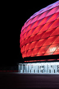 Red building against sky at night