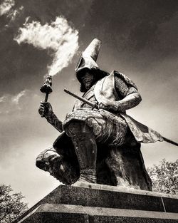 Low angle view of statue against sky