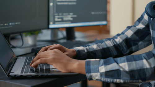 Midsection of man using laptop