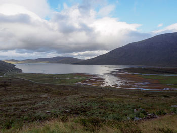 Scenic view of lake and mountains against sky