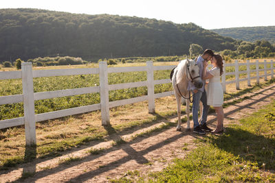 Rear view of couple standing on land