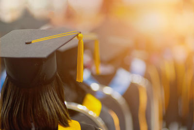 Rear view of woman wearing mortarboard during graduation