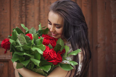 Close-up of young woman holding bouquet