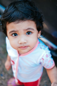 High angle portrait of cute girl standing outdoors