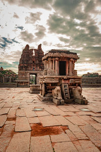 Old temple building against cloudy sky