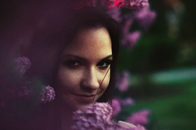 Close-up portrait of young woman in flowers