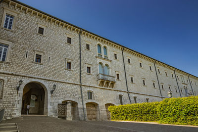 Low angle view of building against clear blue sky