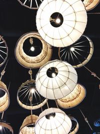 Low angle view of illuminated lighting equipment hanging