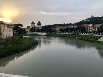 View of river by buildings against sky