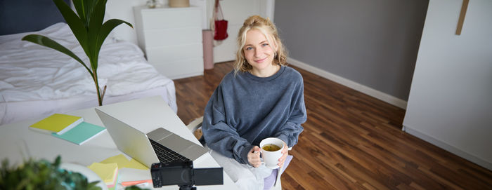 Portrait of young woman using mobile phone