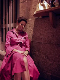 Portrait of young woman sitting on steps