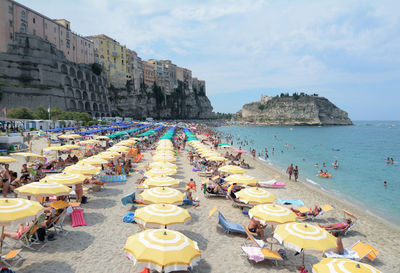 High angle view of people at beach against sky