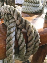 Close-up of rope tied on wooden post
