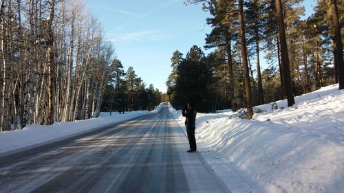 Full length of man standing on road during winter