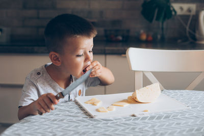 High angle view of boy having food at home