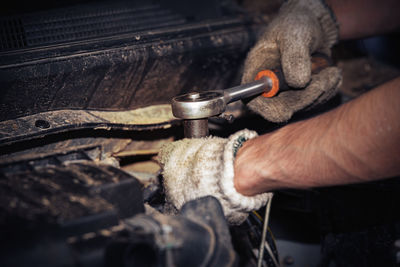 Close-up of man working in machine