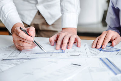 Midsection of people working on table