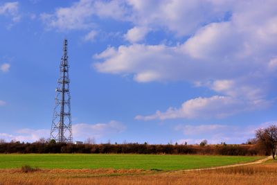 Low angle view of windmill on field against sky