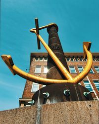 Low angle view of metallic structure against blue sky